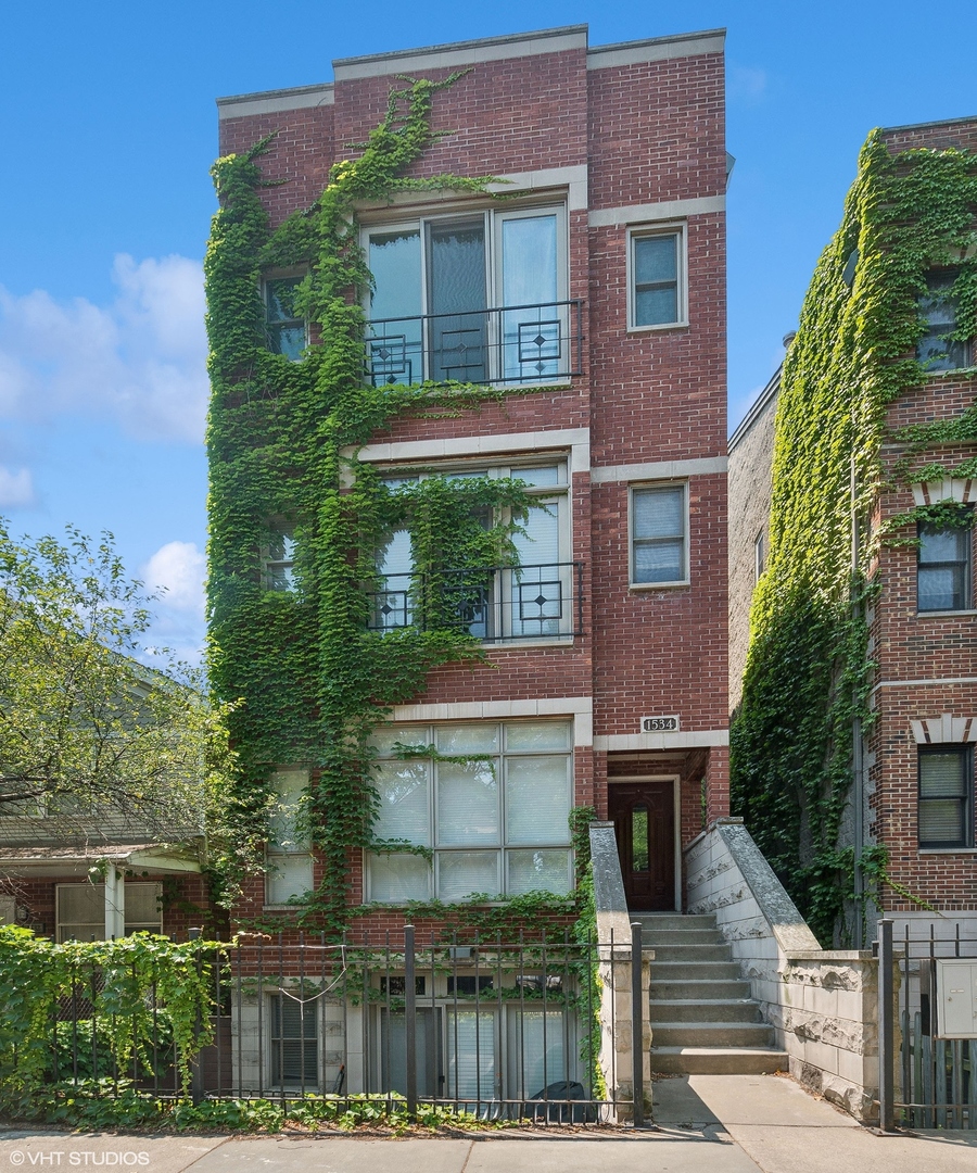 a view of a brick building next to a yard