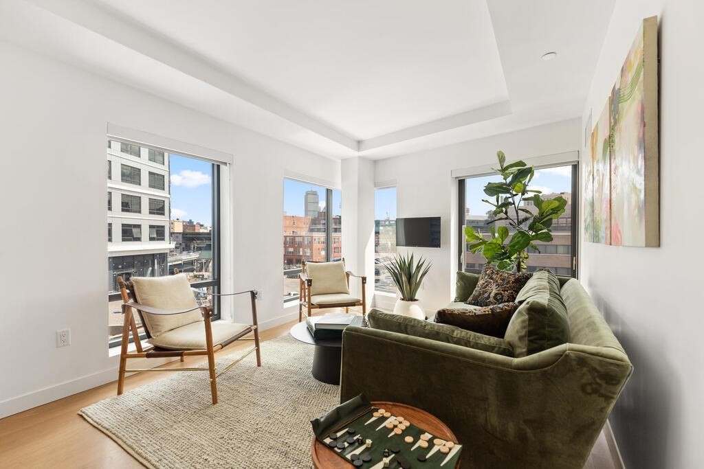 a living room with furniture and a potted plant