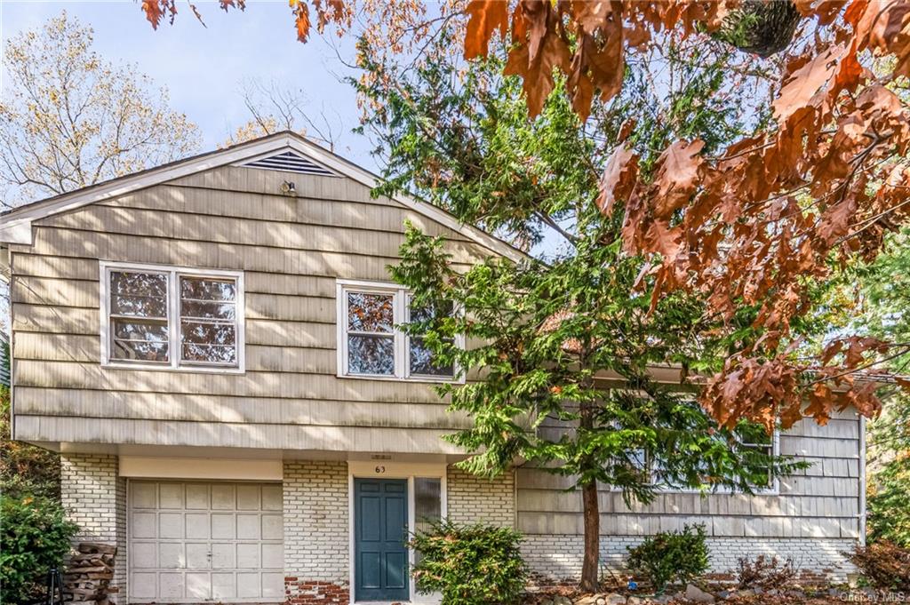 a view of a house with a tree