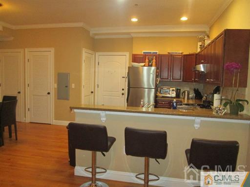 a kitchen with a refrigerator and chairs