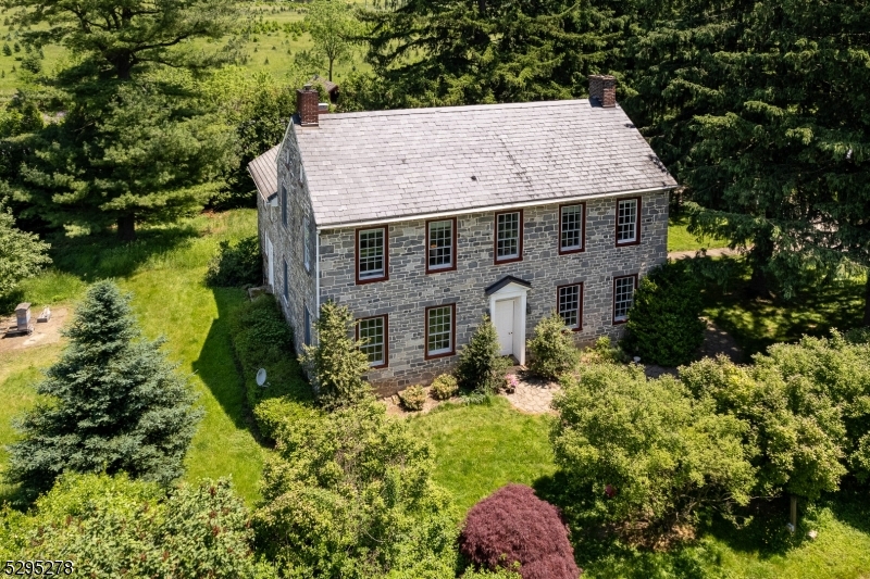 an aerial view of a house with a yard table and chairs