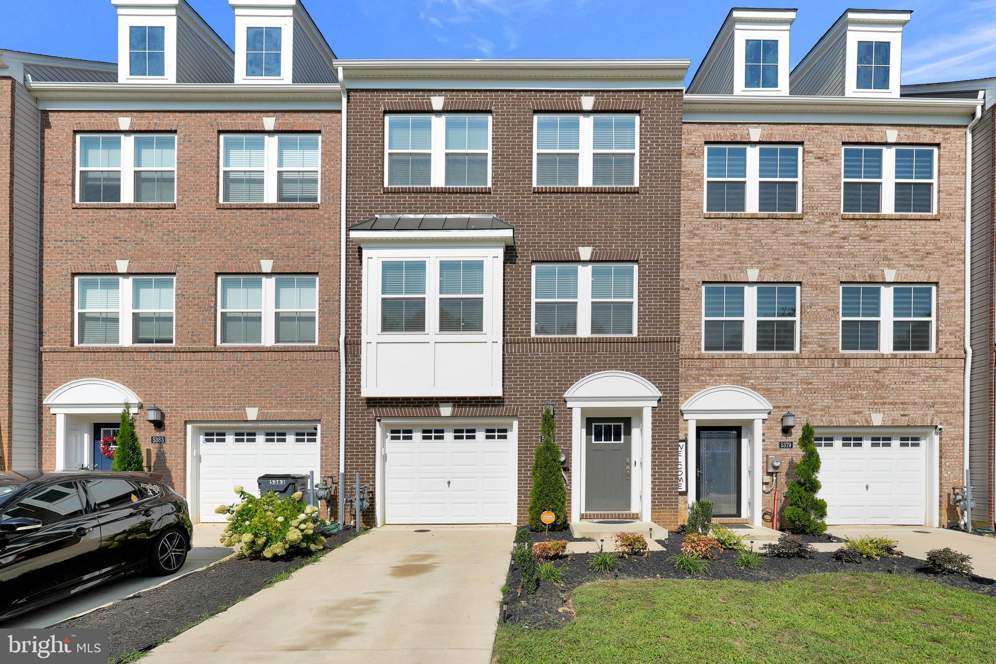 a front view of a residential apartment building with a yard