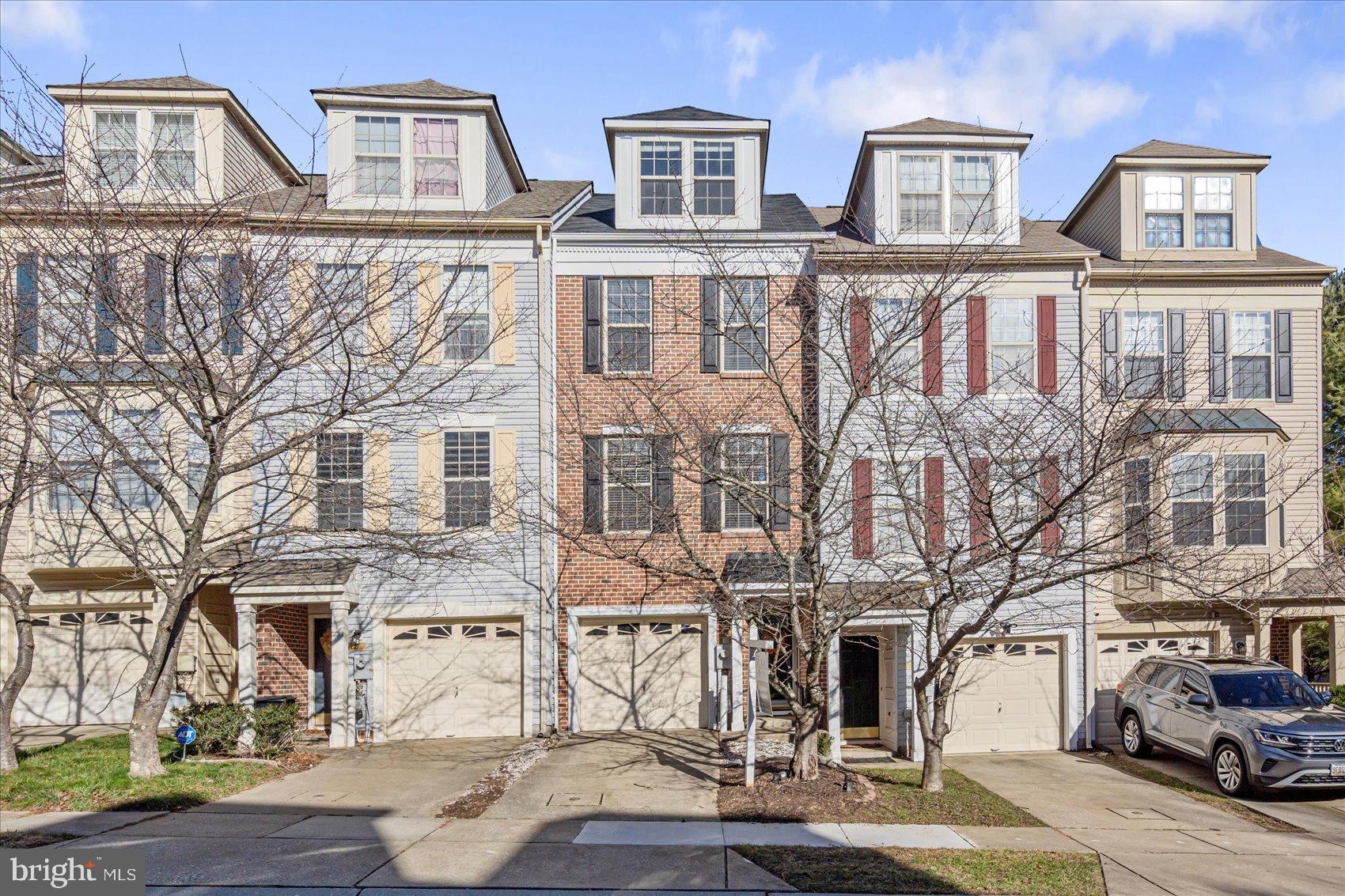 a front view of a residential apartment building with a yard