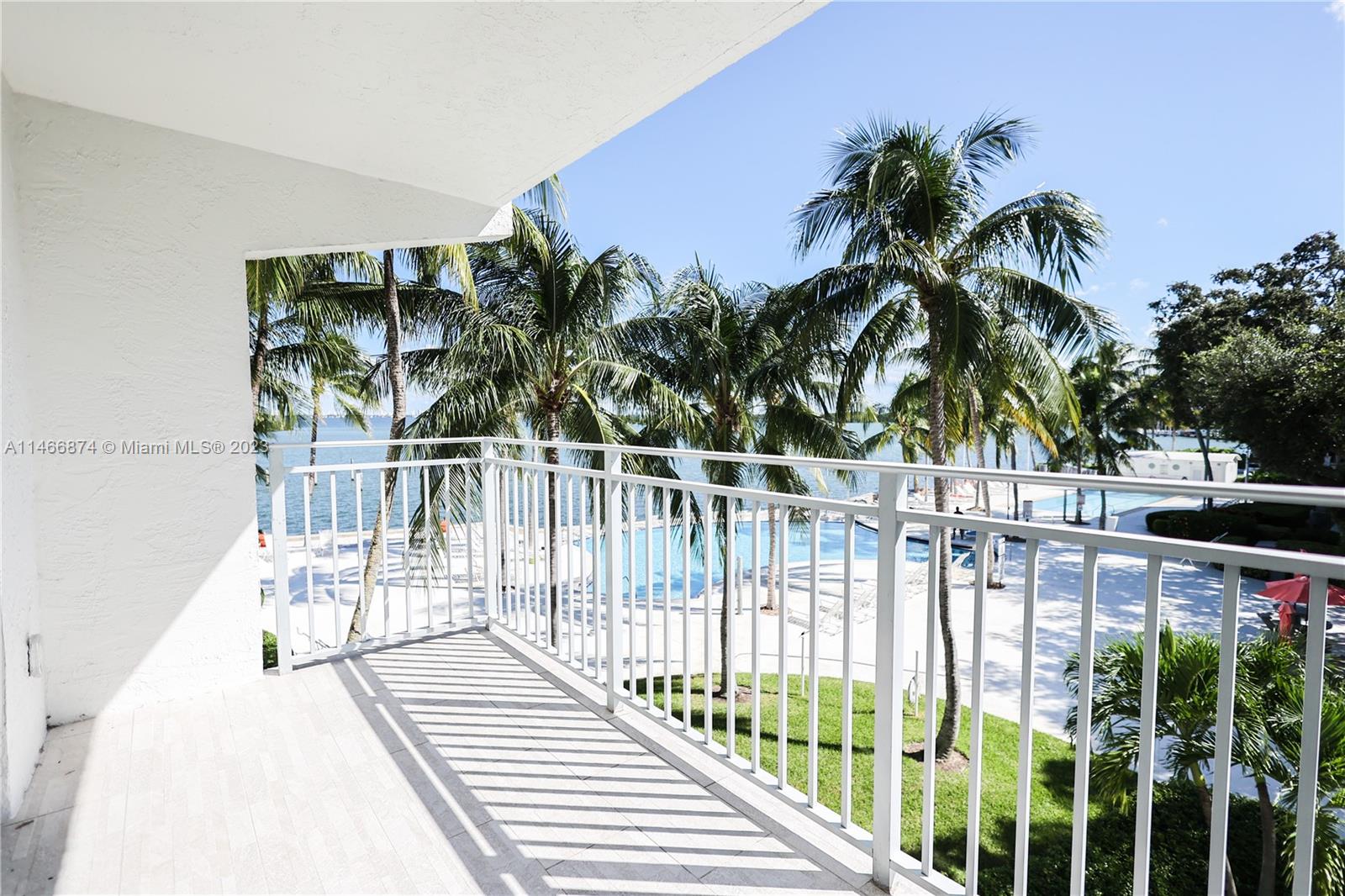 a view of a balcony with wooden floor and fence