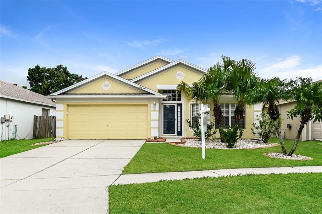 a front view of a house with a yard and garage