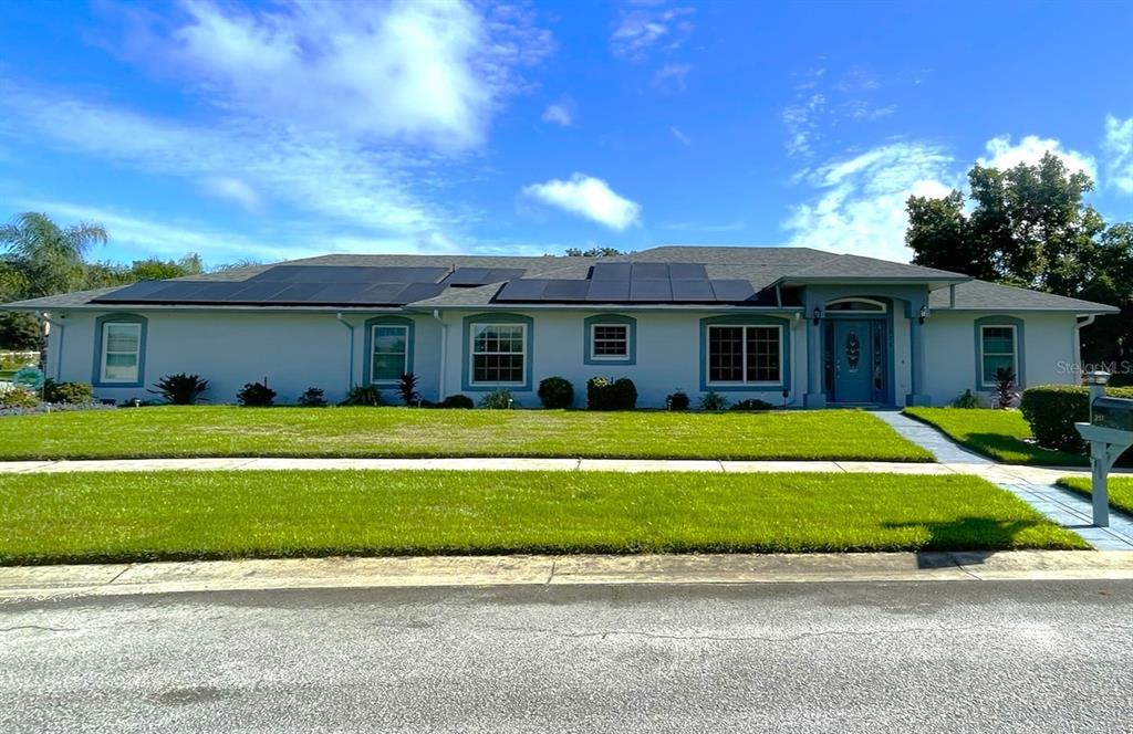 a front view of a house with a garden