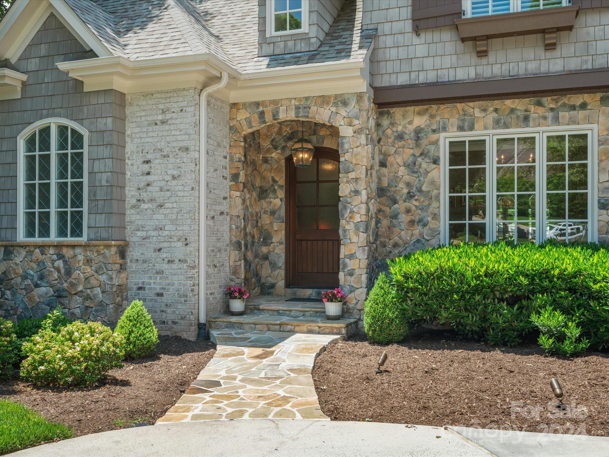 a view of a brick house with potted plants