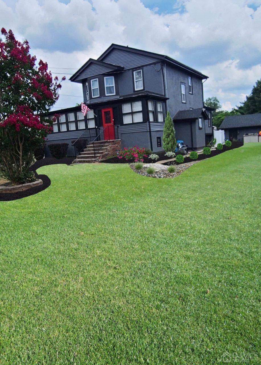 a view of a big house with a big yard and potted plants