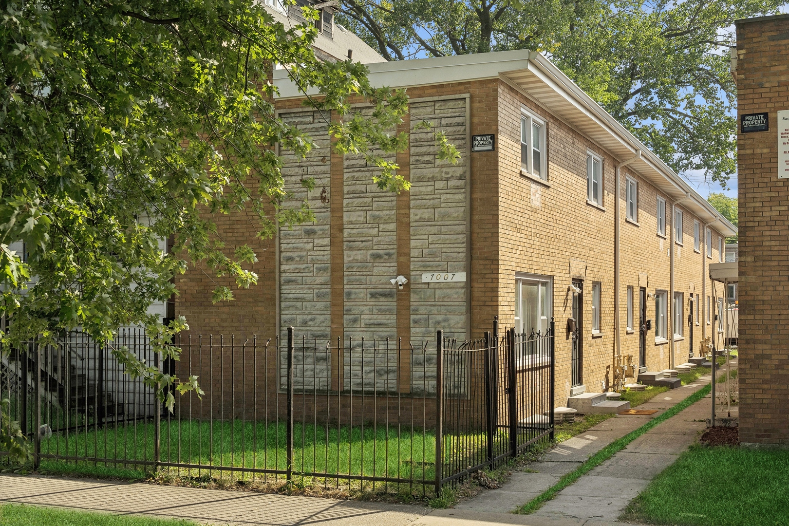 a view of a tall building next to a yard