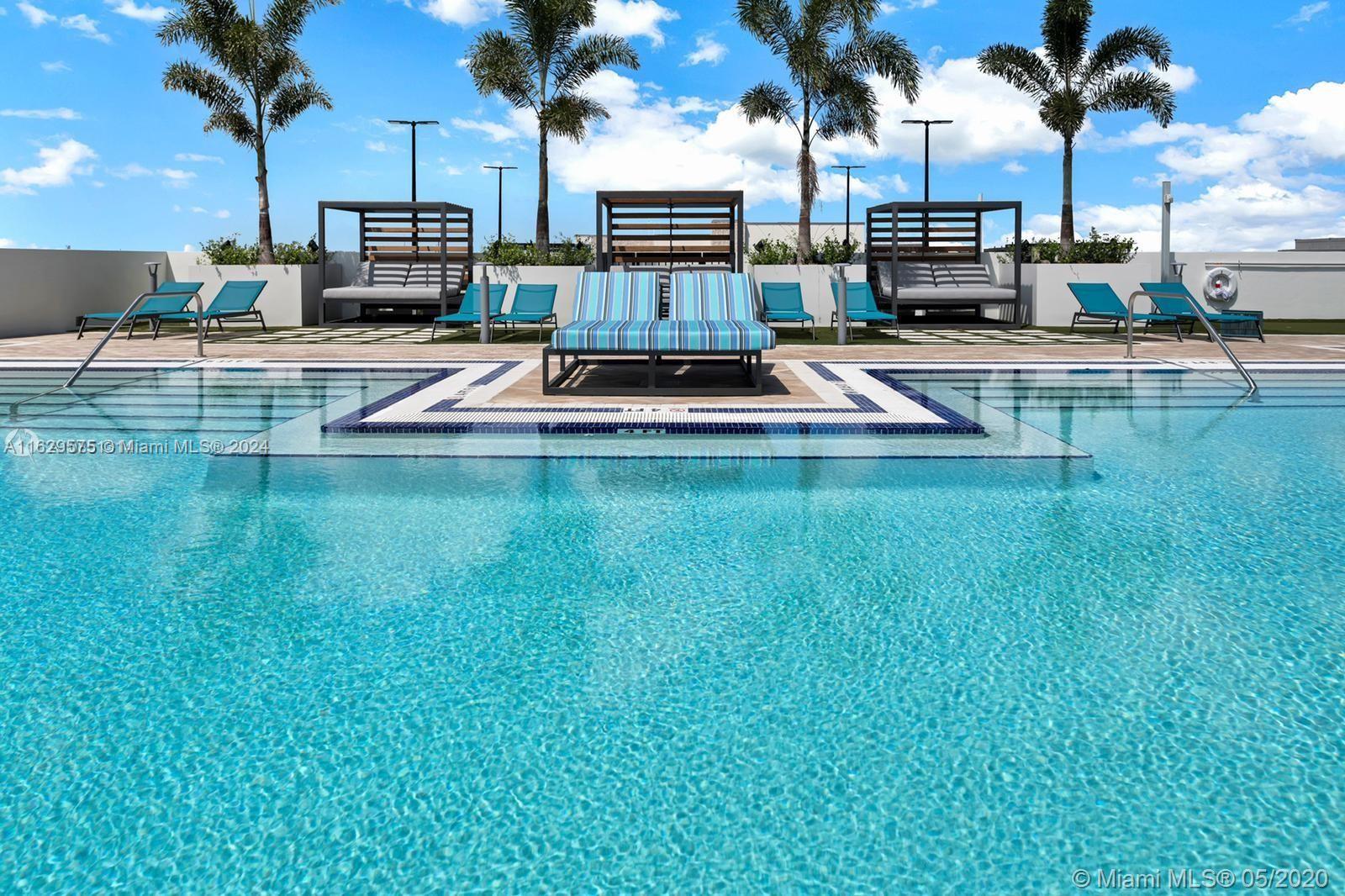 a view of swimming pool with outdoor seating and a patio