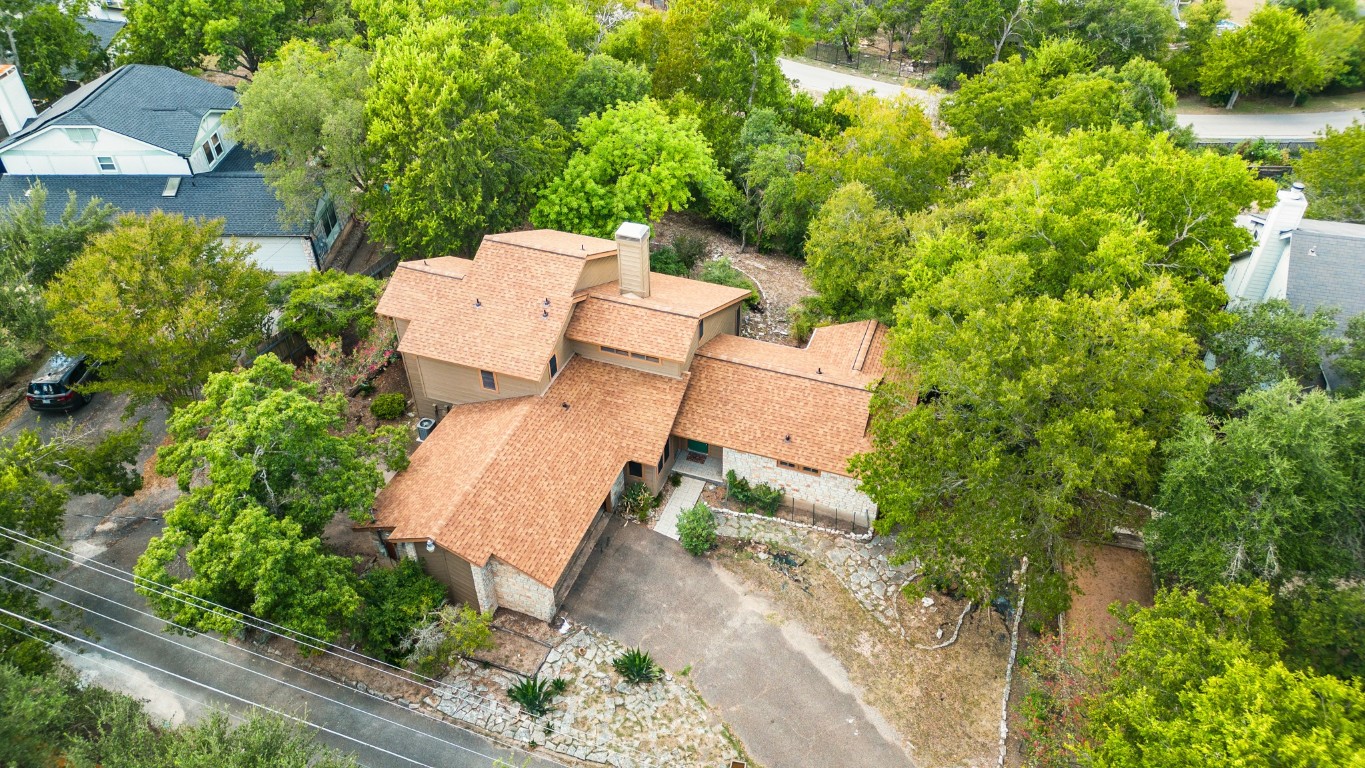 an aerial view of a house with a yard and garden