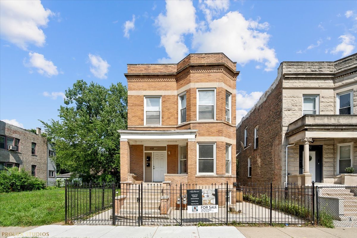 a front view of a residential apartment building with a yard