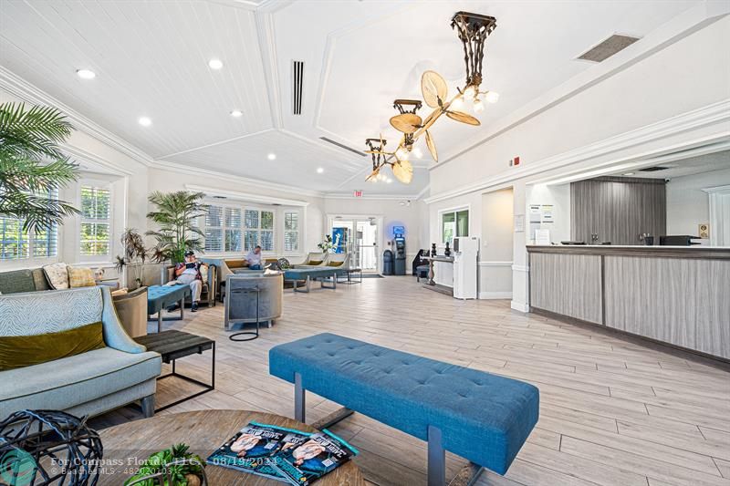 a living room with lots of furniture and kitchen view