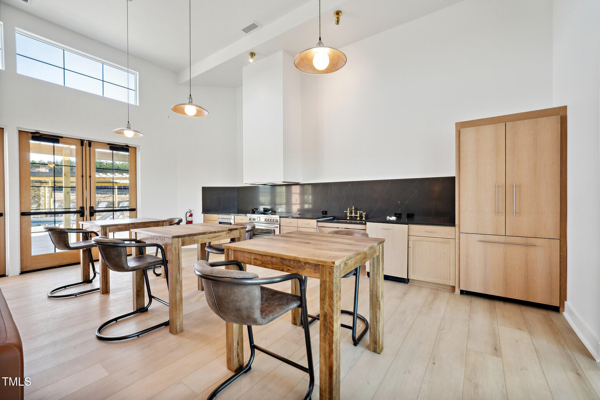 a kitchen with a refrigerator a stove a sink and white cabinets with wooden floor