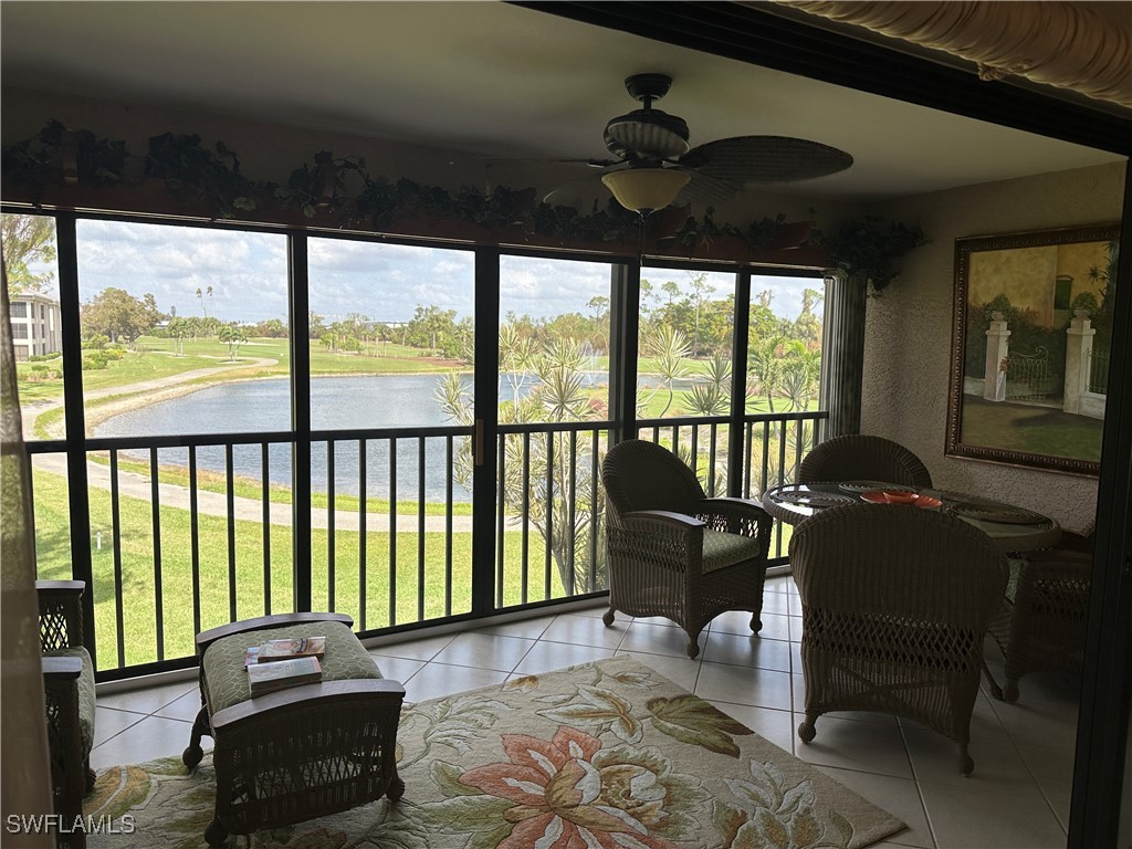 a living room with furniture and floor to ceiling windows