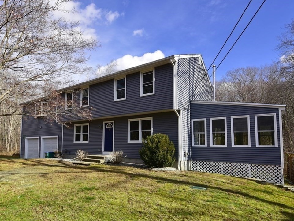 a front view of a house with a yard