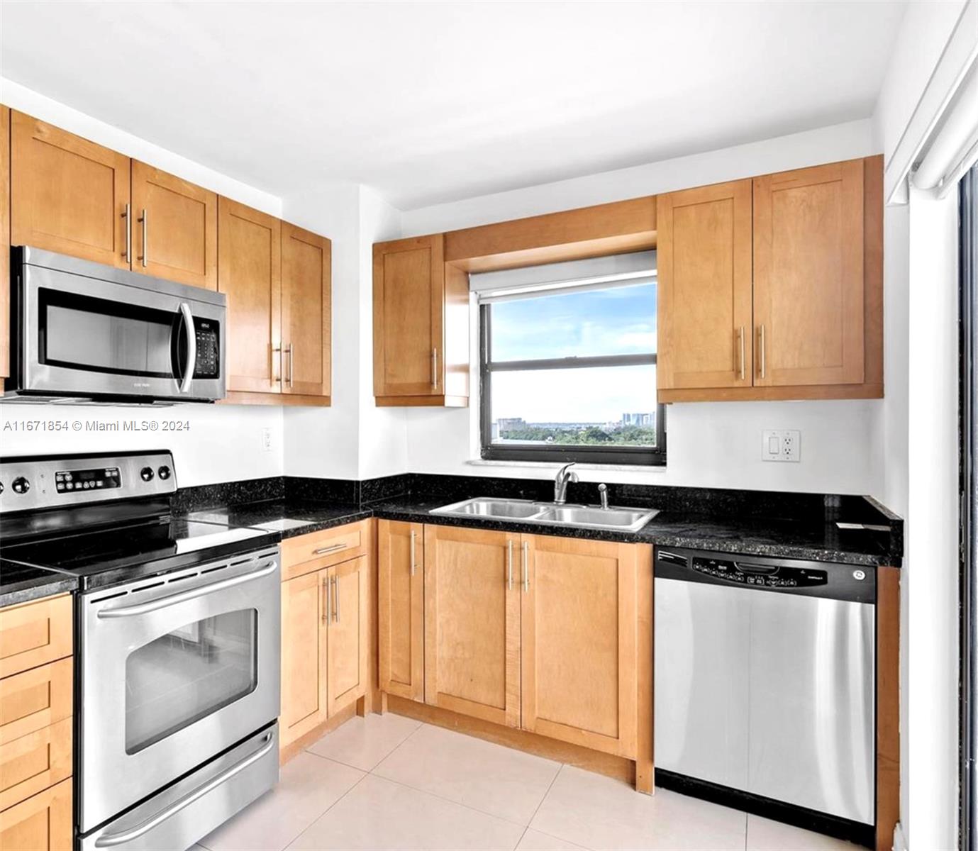 a kitchen with granite countertop white cabinets and appliances