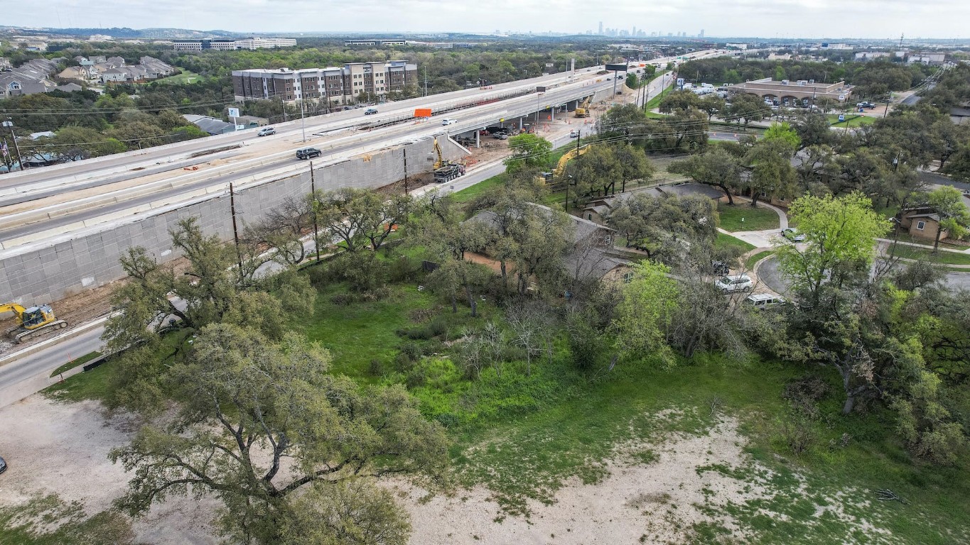 an aerial view of a house with a yard and lake view