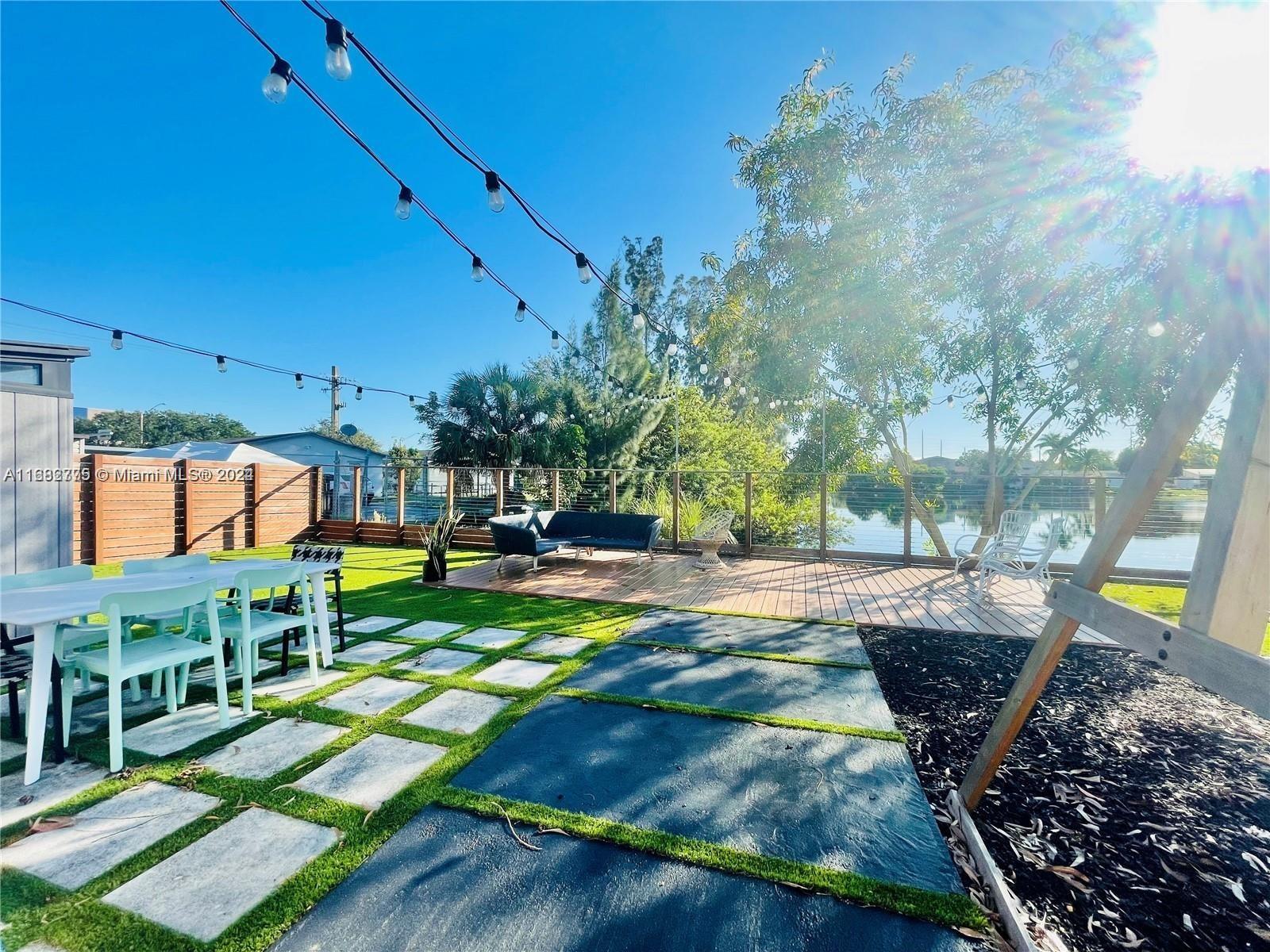 a view of a backyard with sitting area