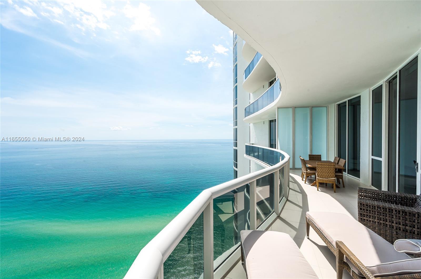 a balcony with wooden floor and furniture