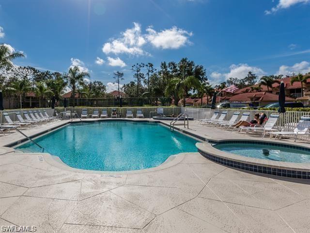 a view of a swimming pool with outdoor seating