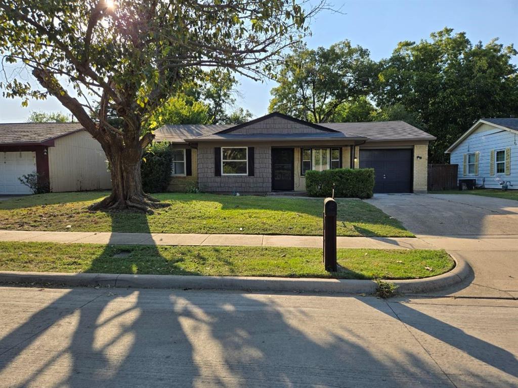 a front view of house with yard and trees