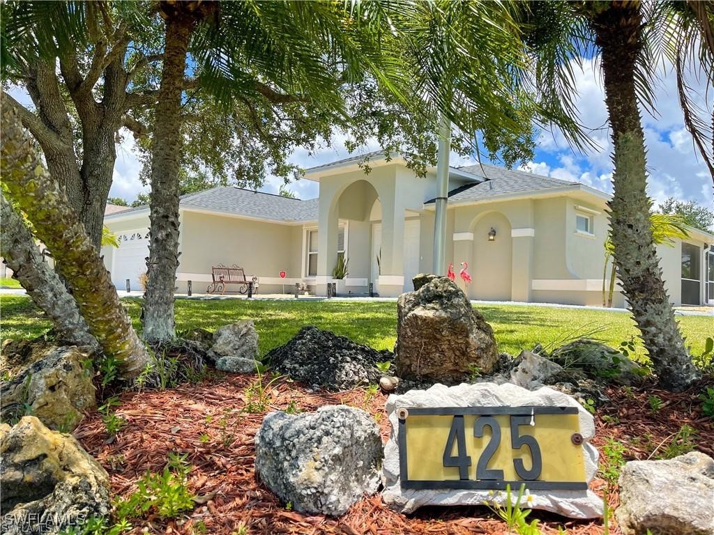 a front view of a house with garden