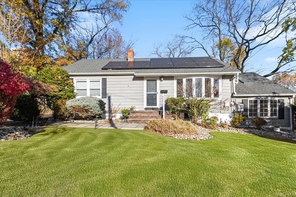 a view of a house with backyard sitting area and garden