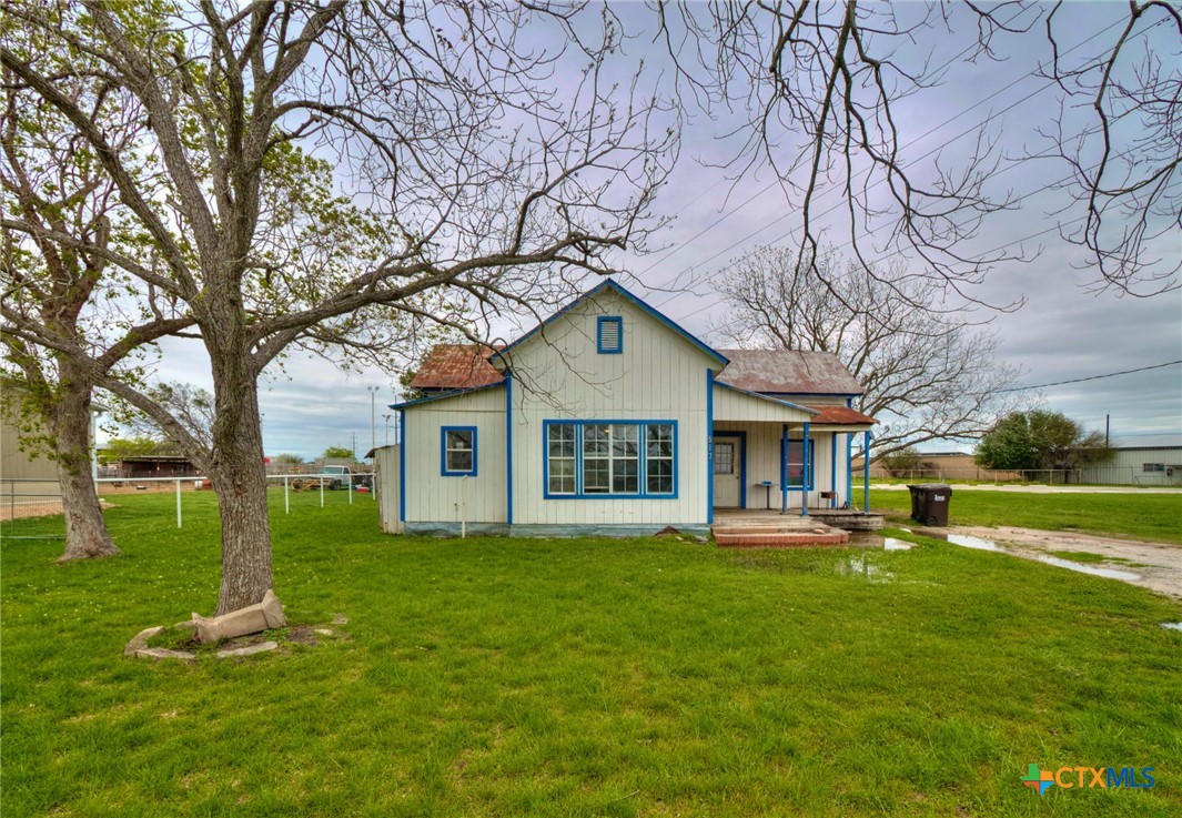 a front view of house with yard and green space