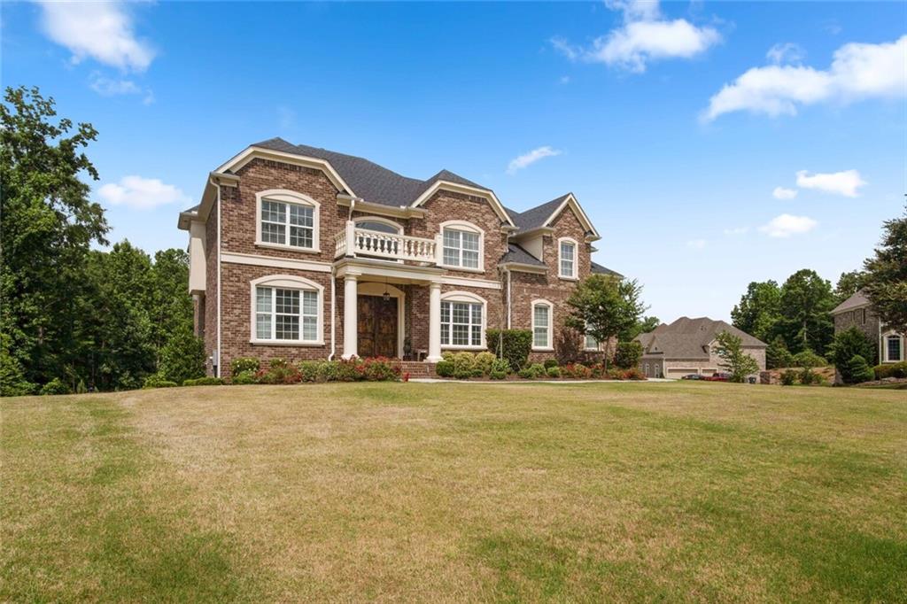 a front view of a house with a garden