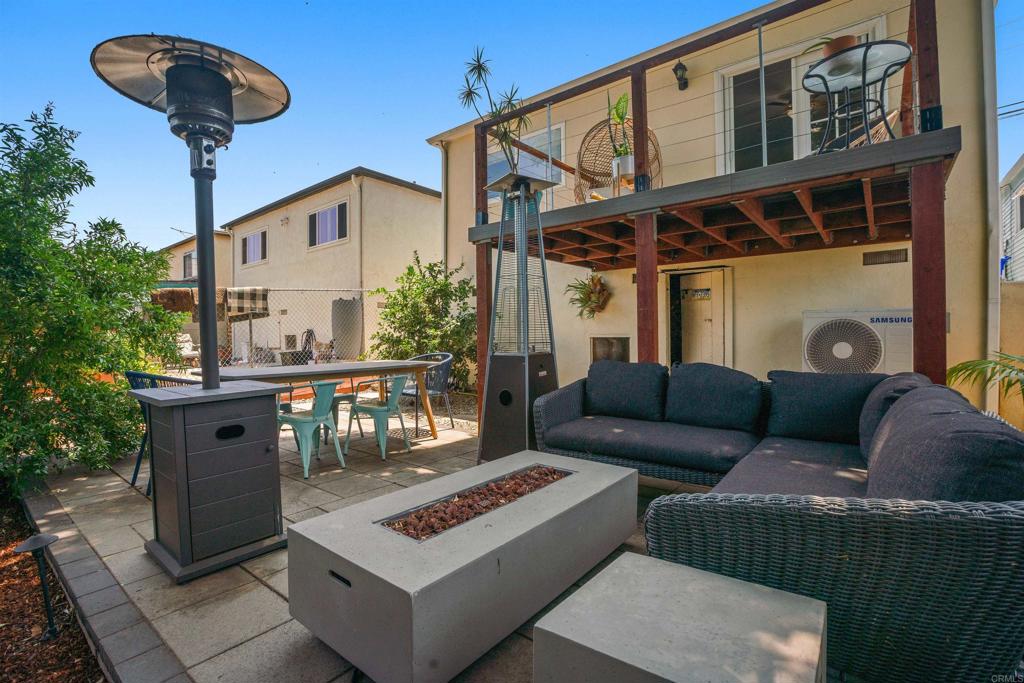 a view of a patio with couches and a potted plant