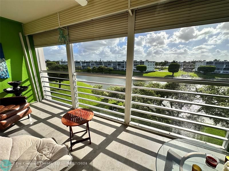 a view of a chairs and table in the balcony