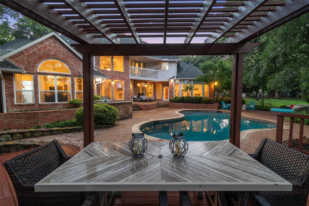 a view of a porch with furniture and a backyard