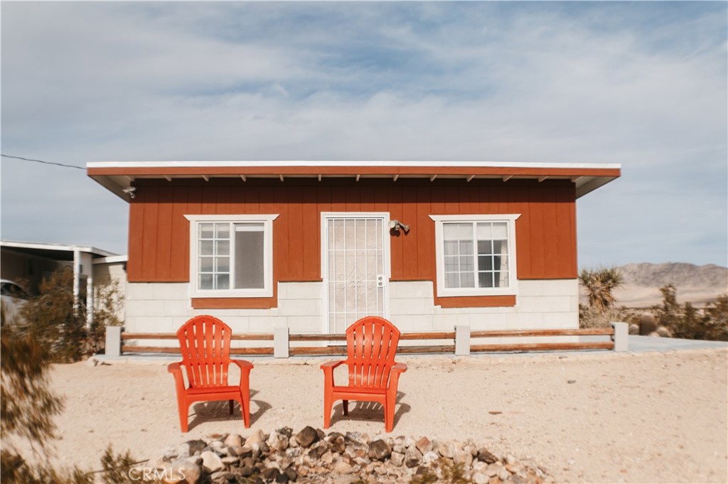 a backyard of a house with table and chairs