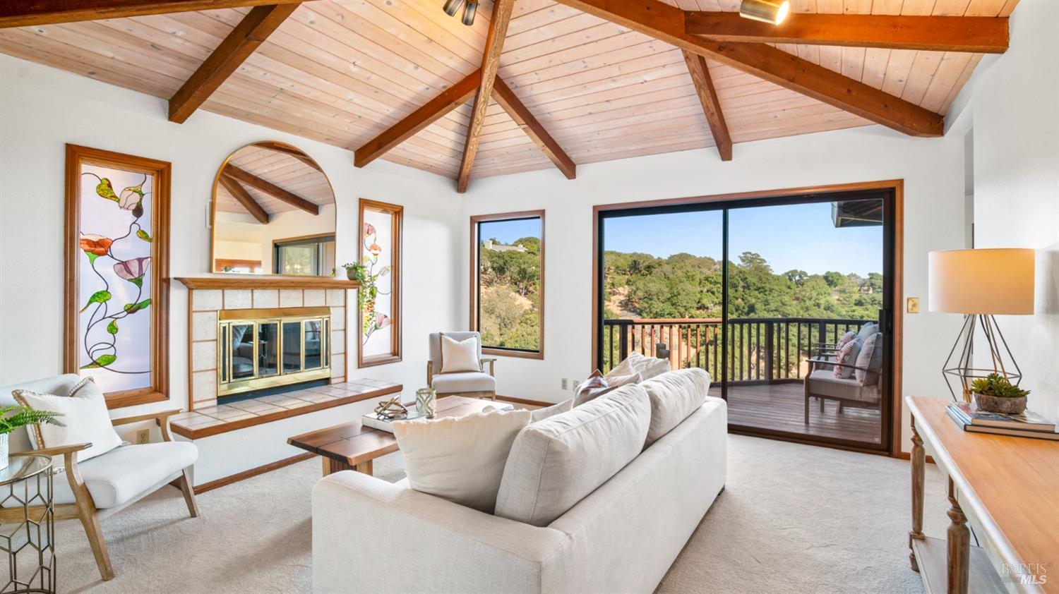 a living room with furniture a large window and a flat screen tv