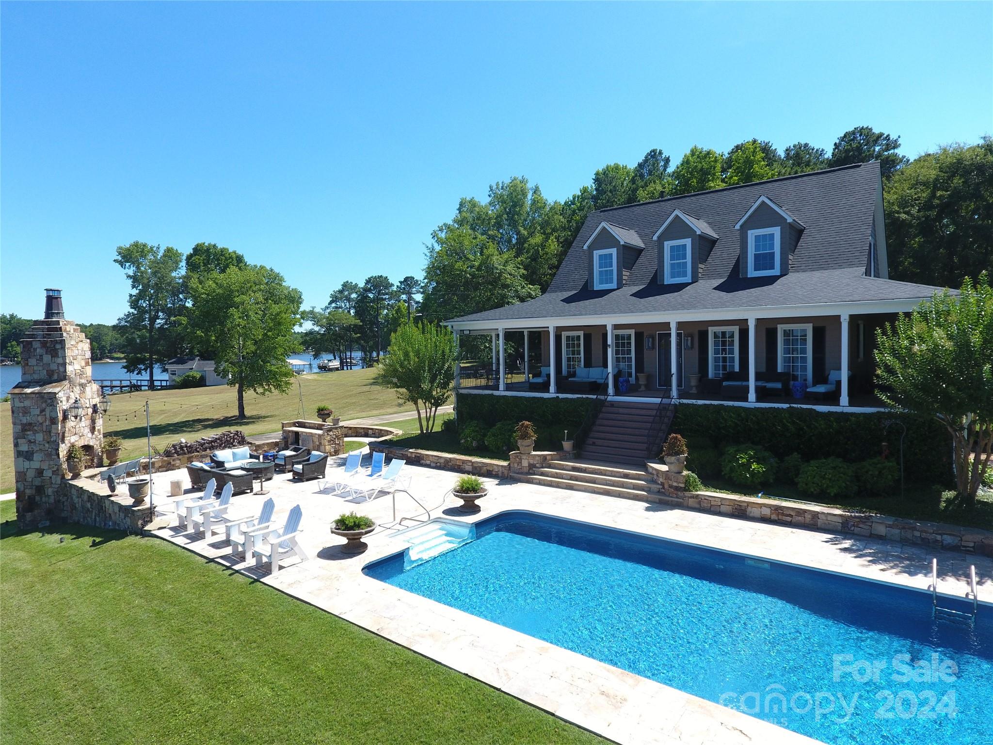 a view of swimming pool with outdoor seating and a garden