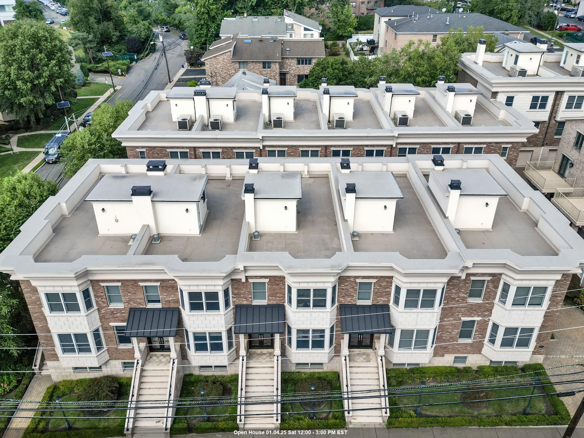 a aerial view of a residential apartment building with a yard