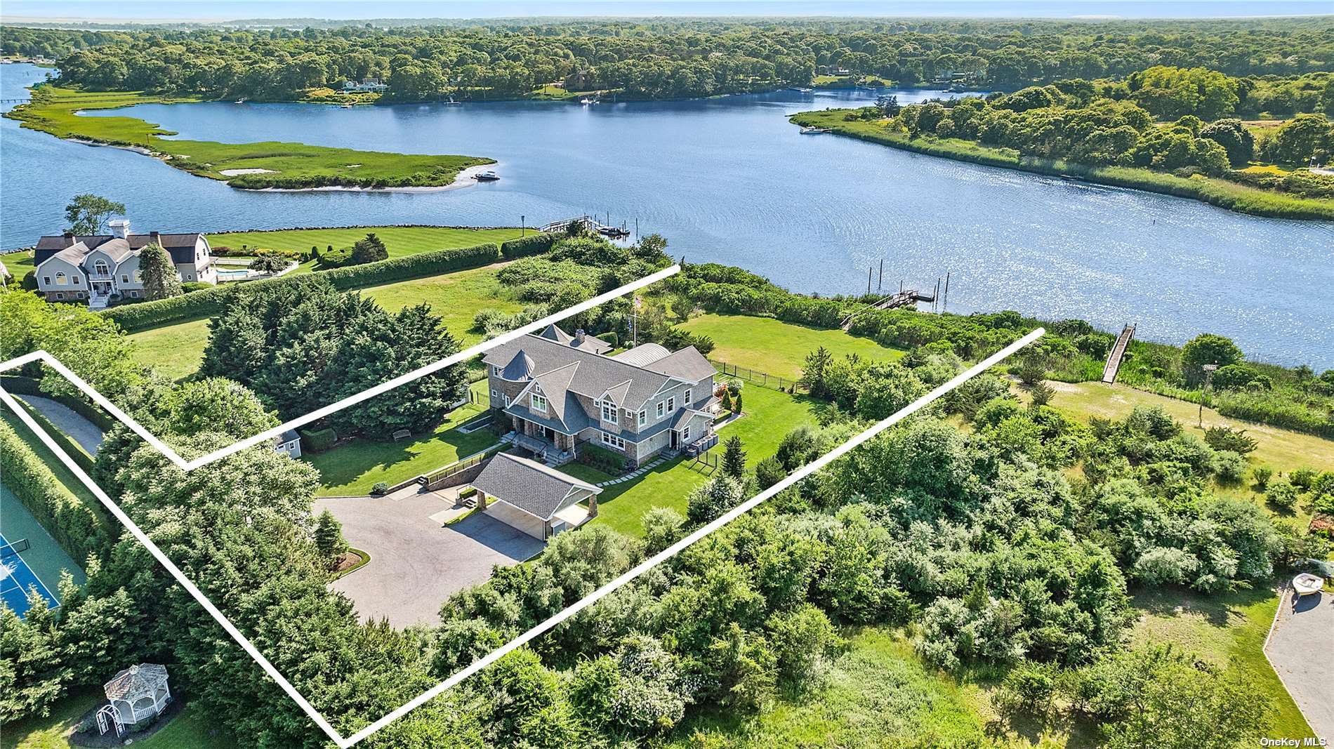 an aerial view of a house with a garden and lake view