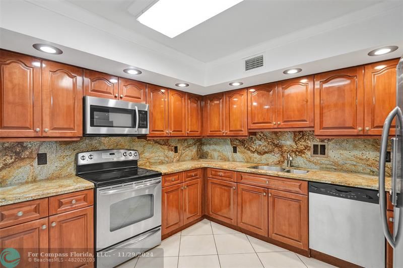 a kitchen with a sink stove top oven and cabinets