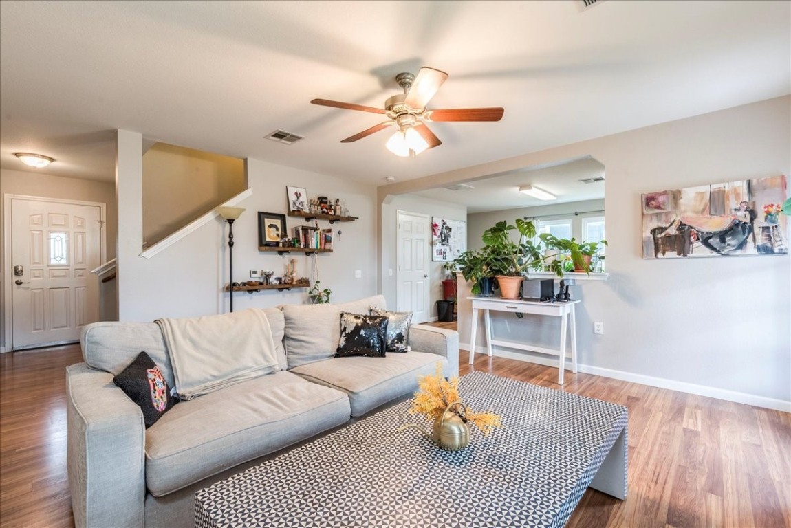 a living room with furniture a window and a chandelier