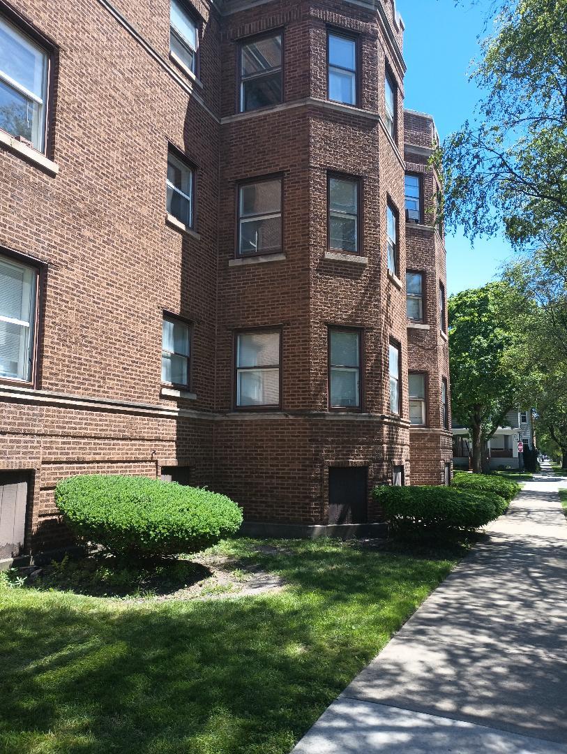 a view of a brick building next to a yard