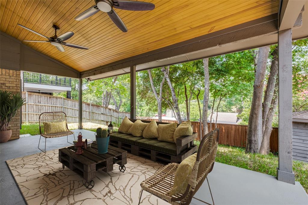 a living room with patio furniture and a floor to ceiling window