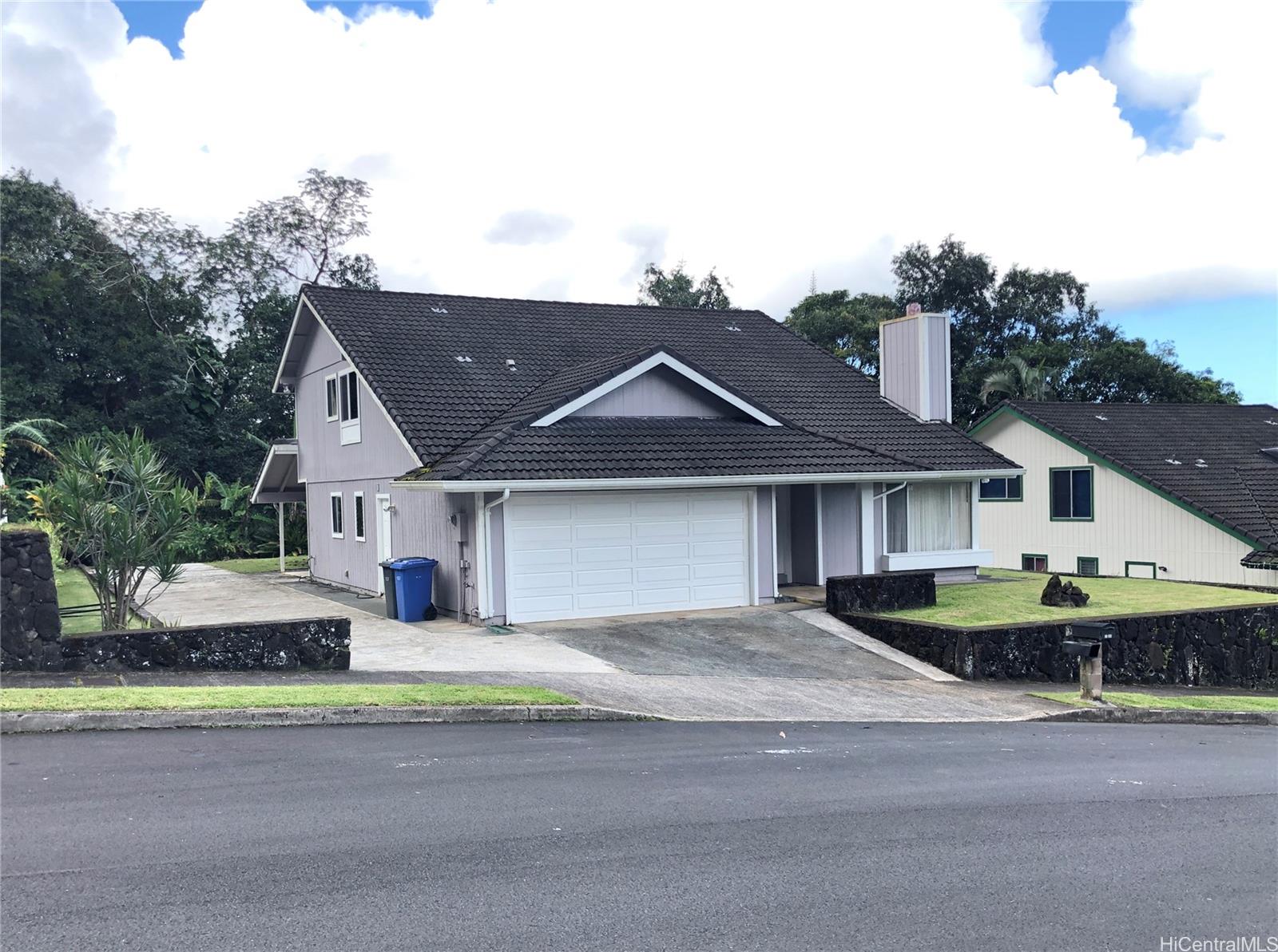 a front view of house with yard and trees