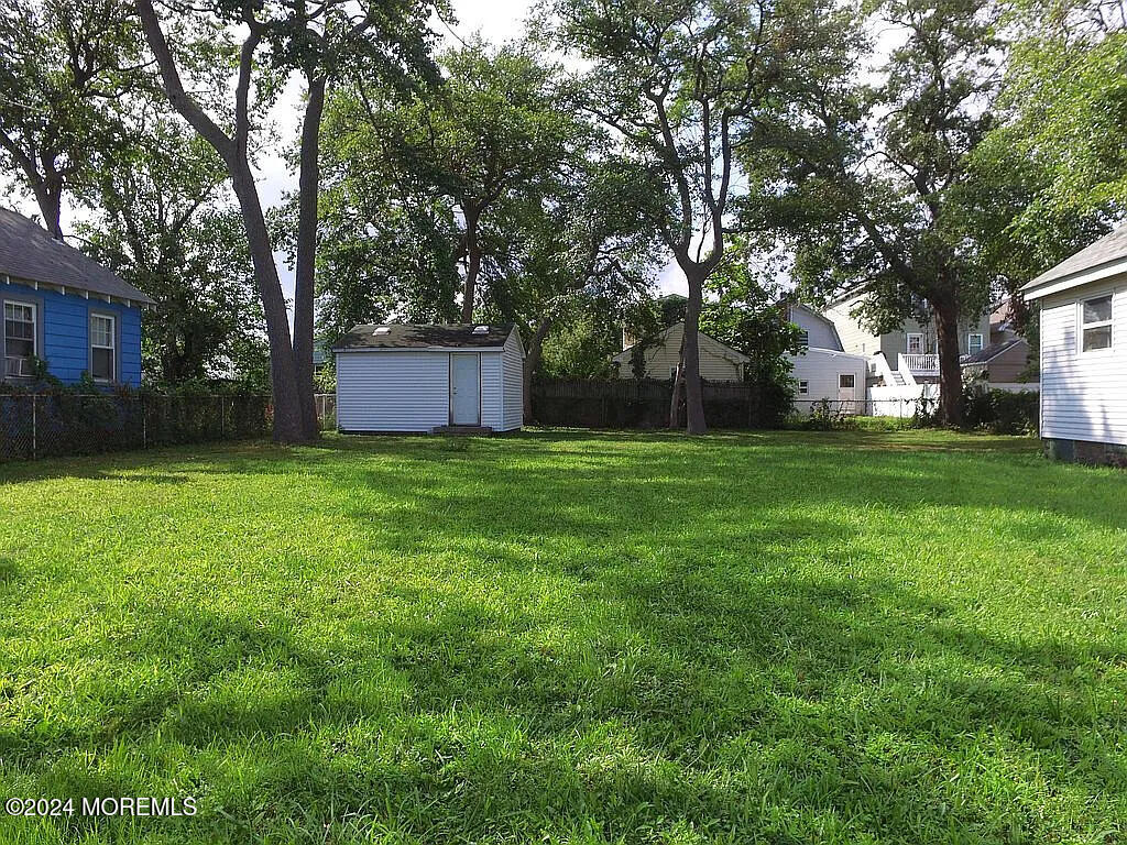 a view of a yard with a house and large trees