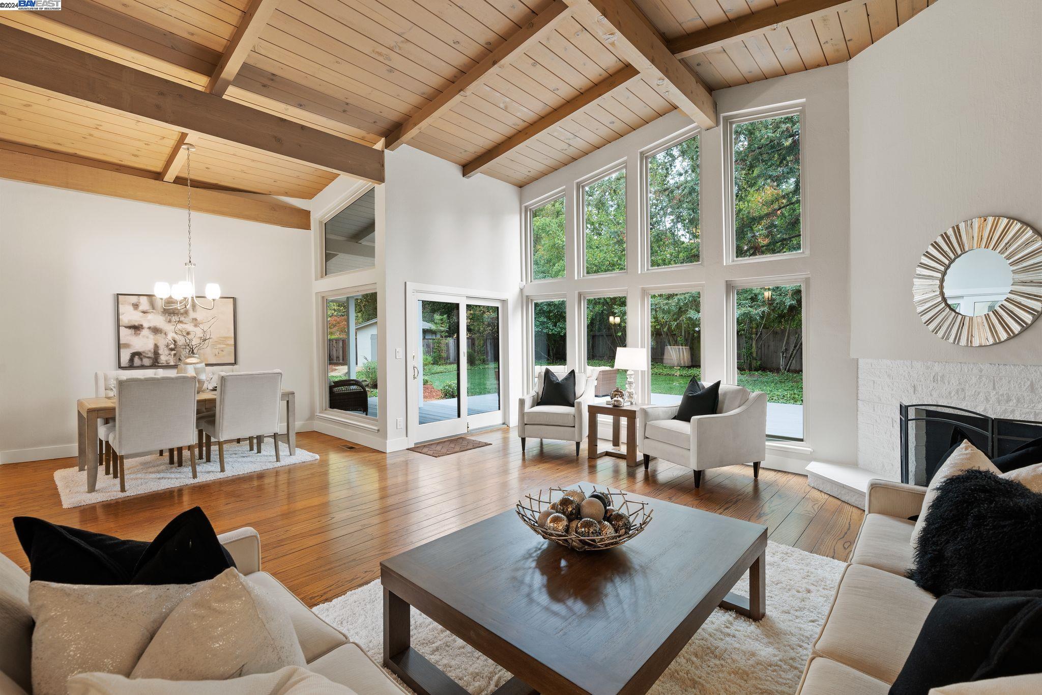 a living room with furniture a table and a large window