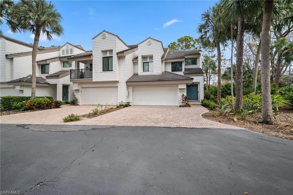 View of property with a balcony and a garage