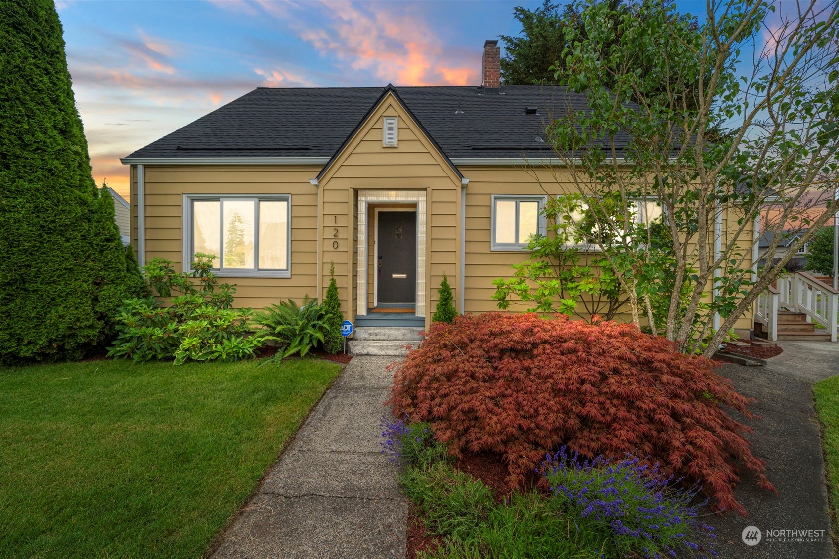 a front view of a house with garden