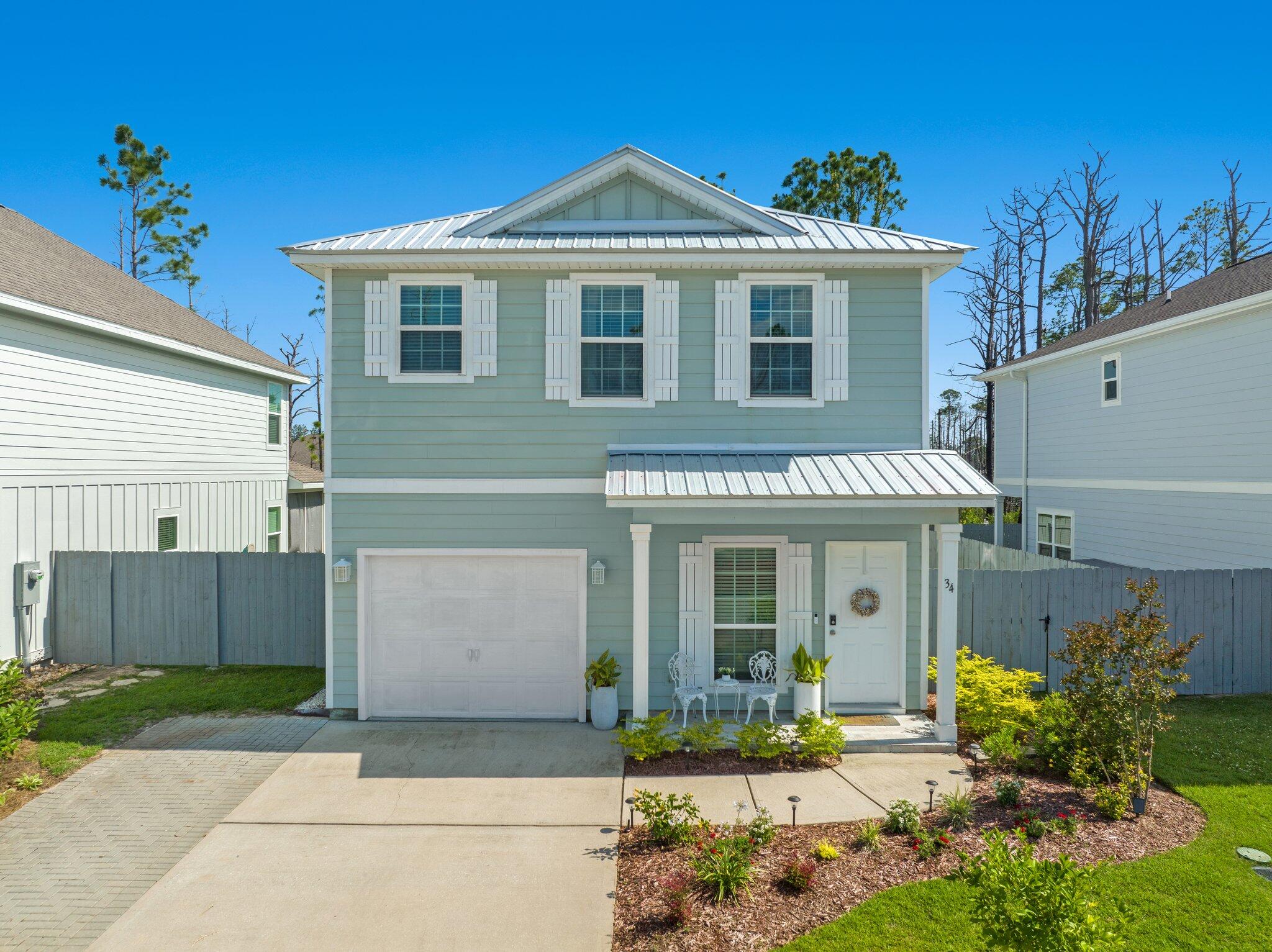 a front view of a house with a yard and outdoor seating