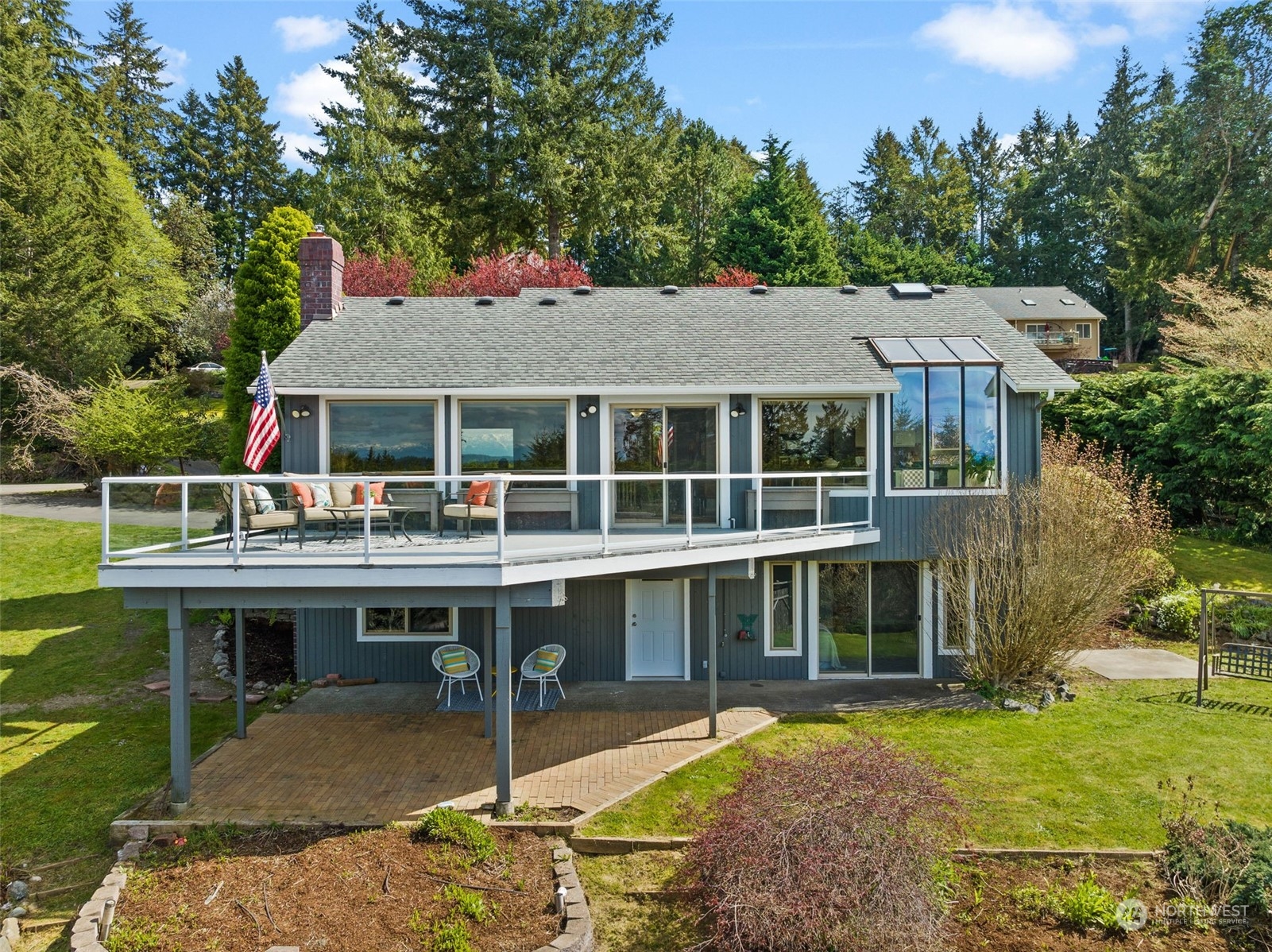 a view of house with a yard outdoor seating and swimming pool