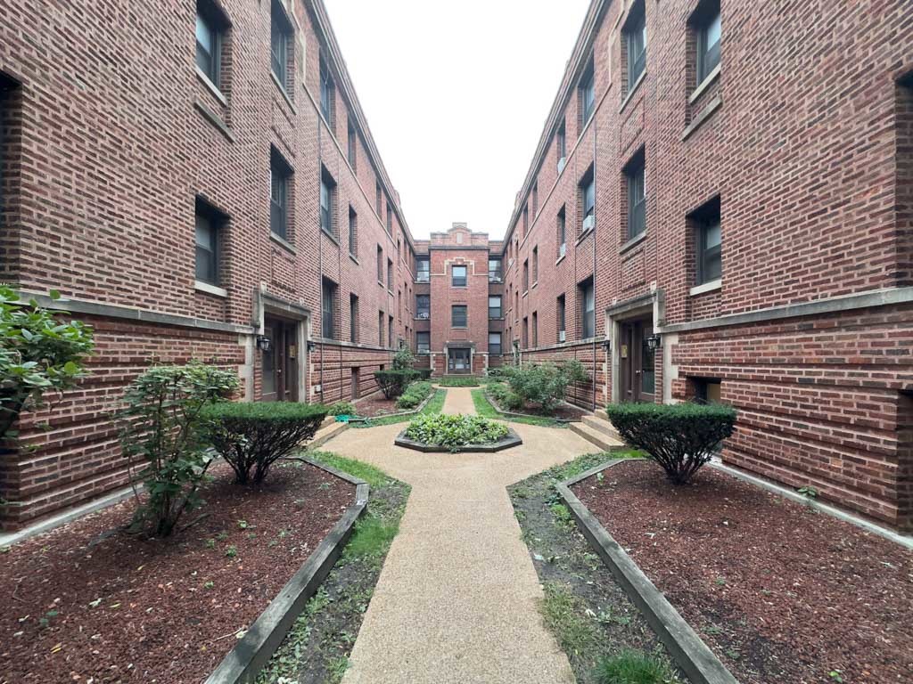 a view of a building with garden and plants